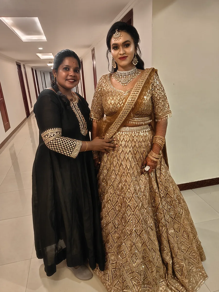 Woman in a gold embellished gown with formal makeup and hairstyle