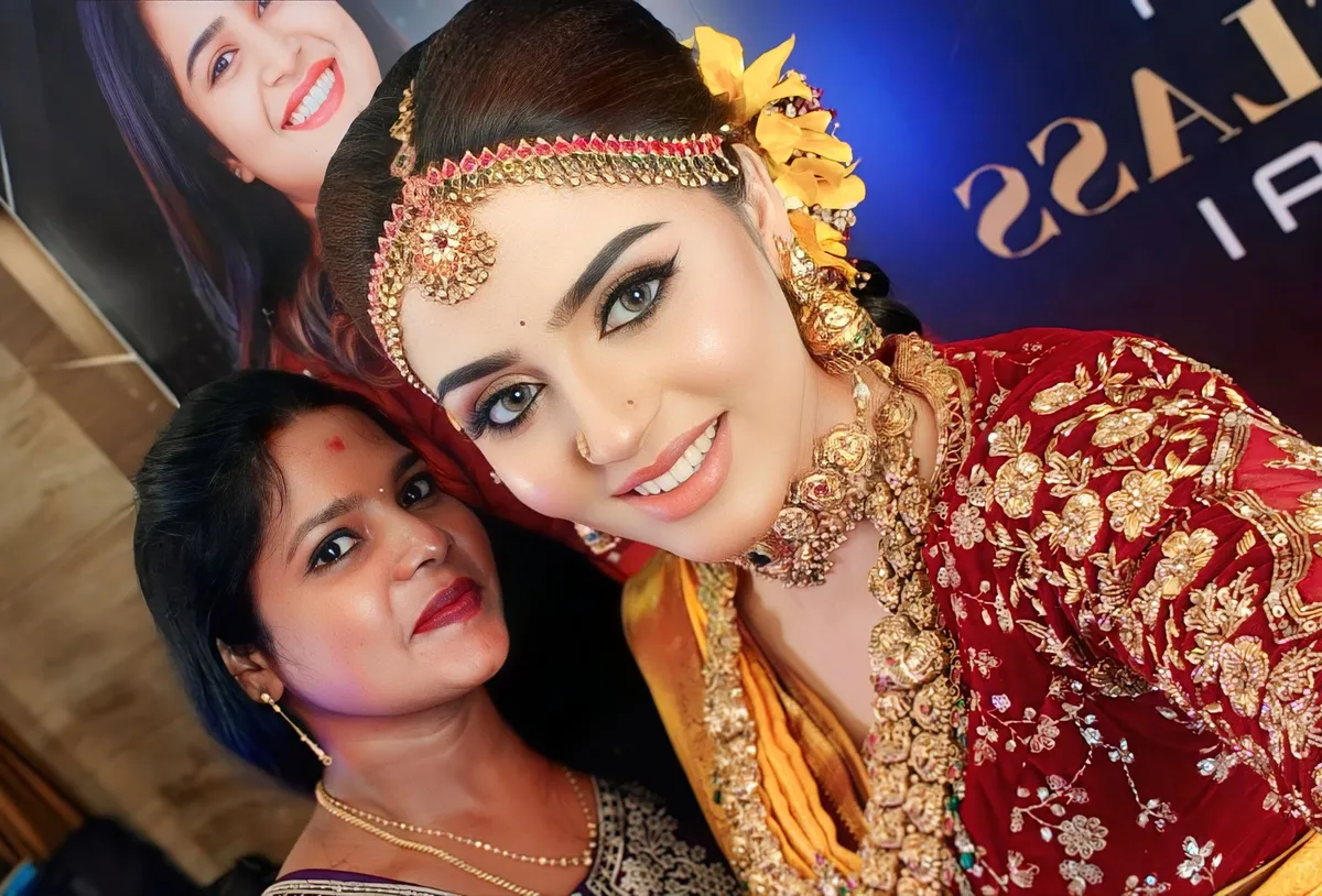 Close-up of a bride with gold jewellery, floral hair styling and wedding makeup